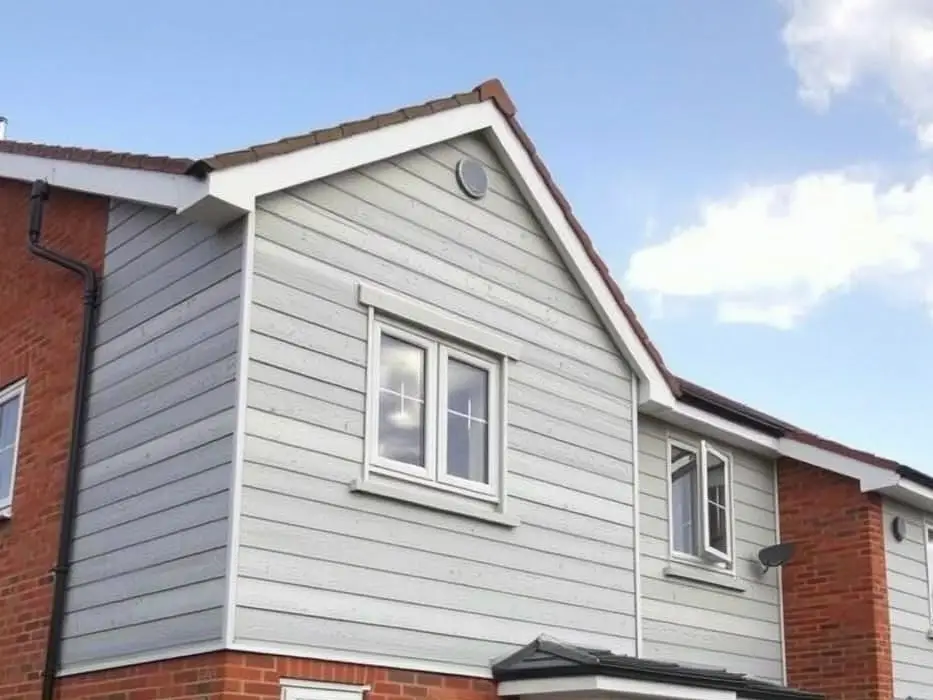 Example image: a house with light grey horizontal weatherboard cladding on its upper storey